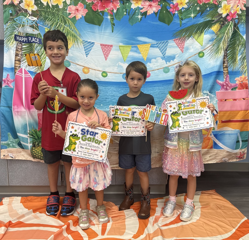 STAR Gators pose in front of a beach-themed backdrop.
