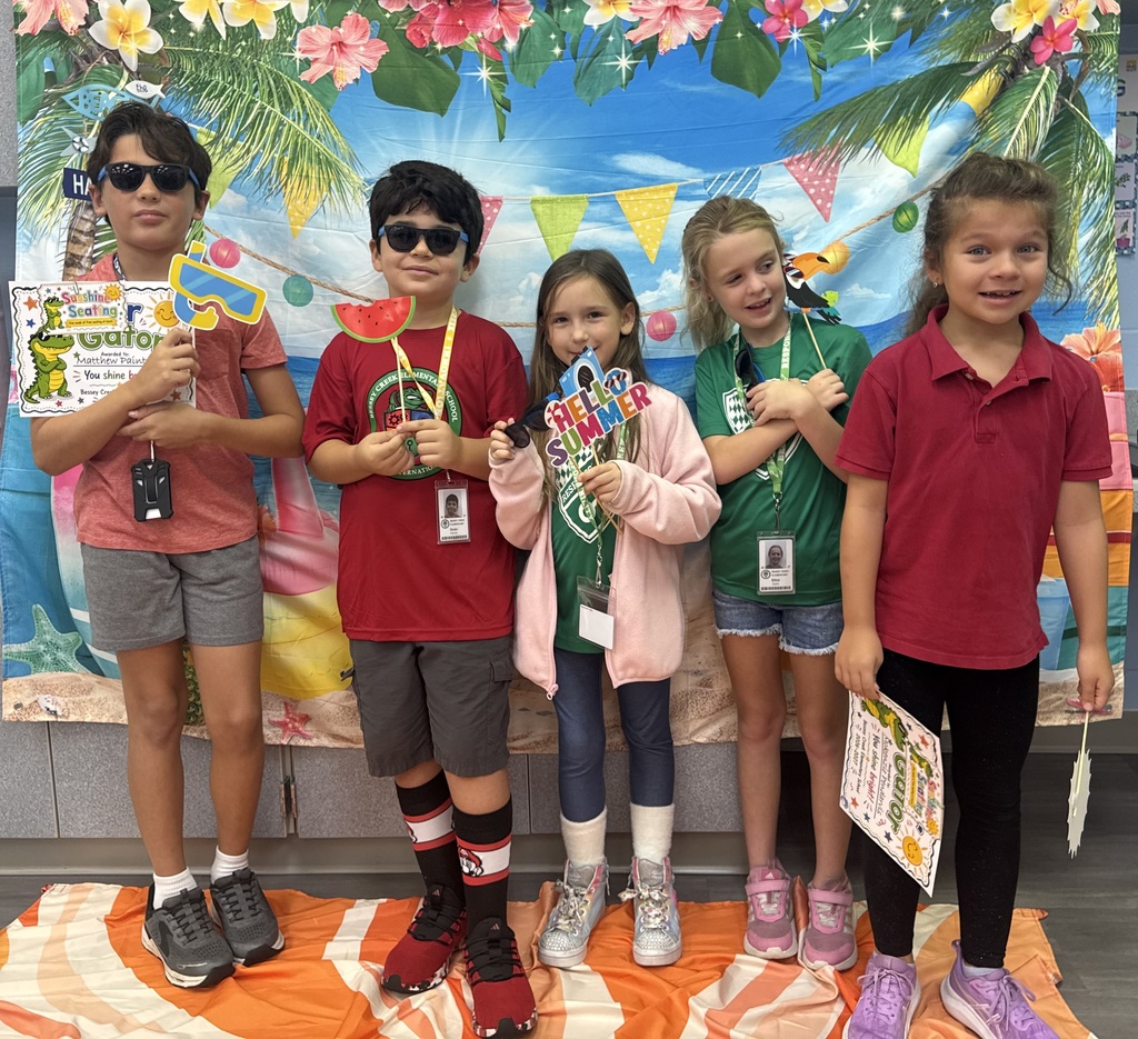 STAR Gators pose in front of a beach-themed backdrop.