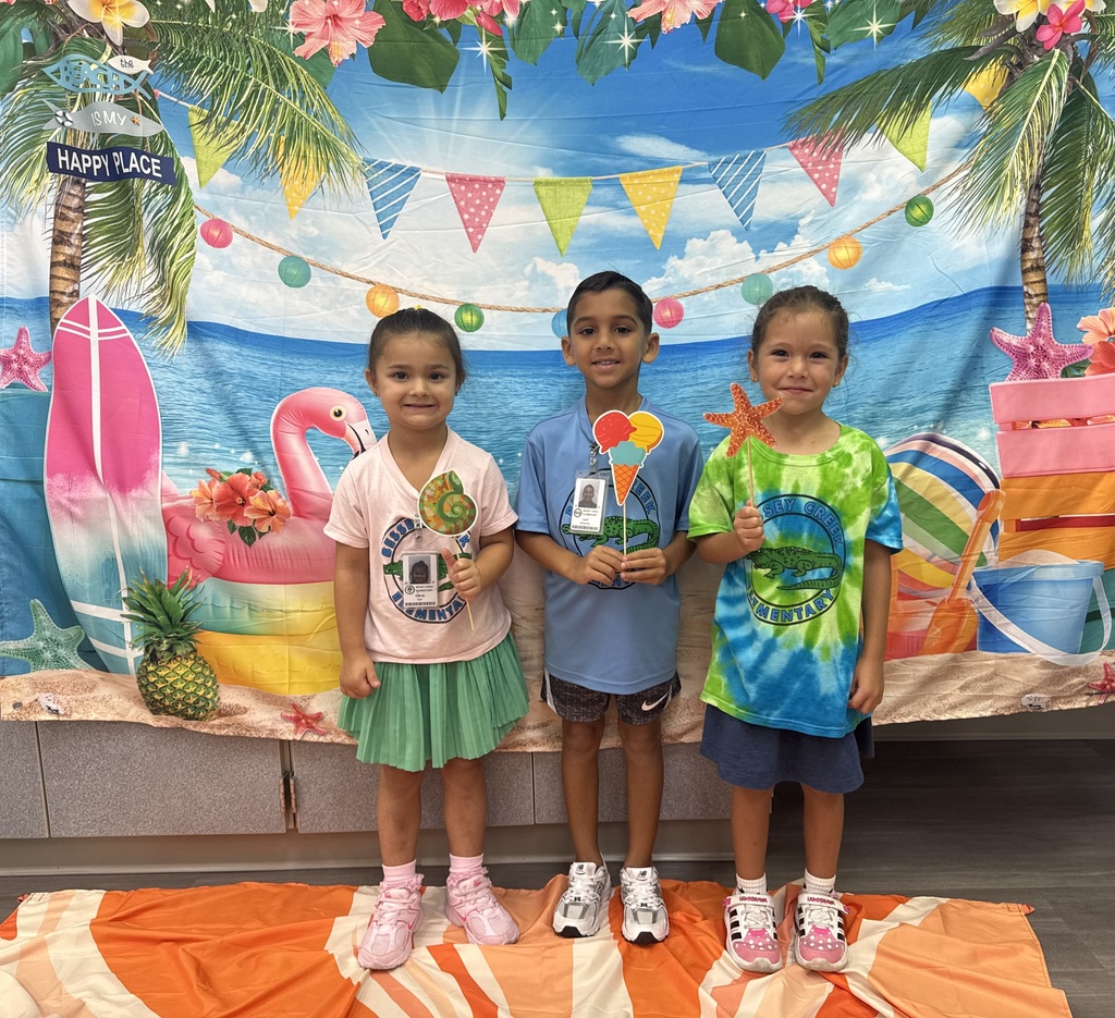 STAR Gators pose in front of a beach-themed backdrop.