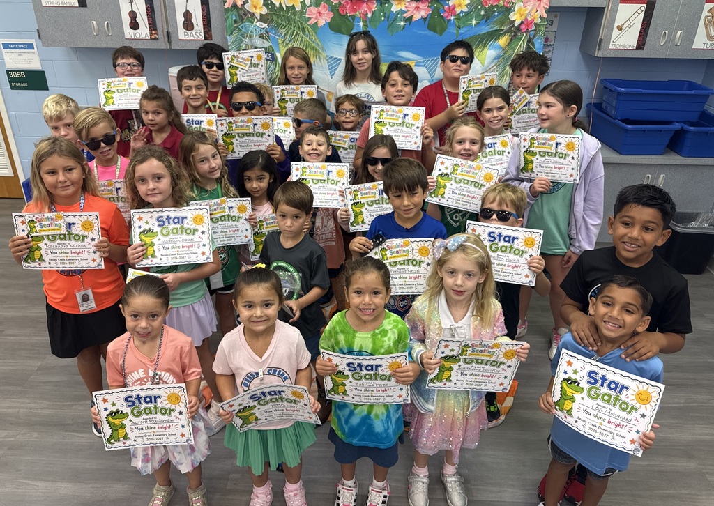 STAR Gators pose in front of a beach-themed backdrop.