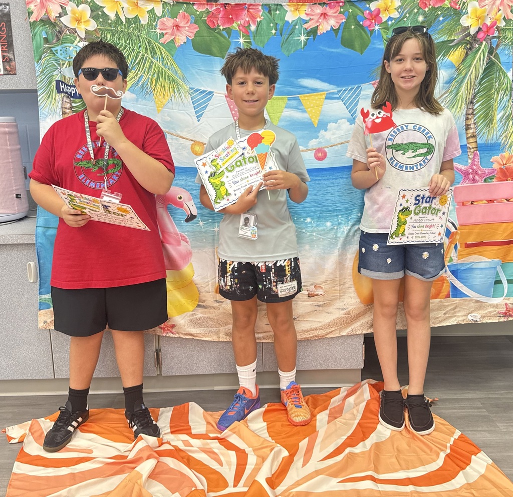 STAR Gators pose in front of a beach-themed backdrop.