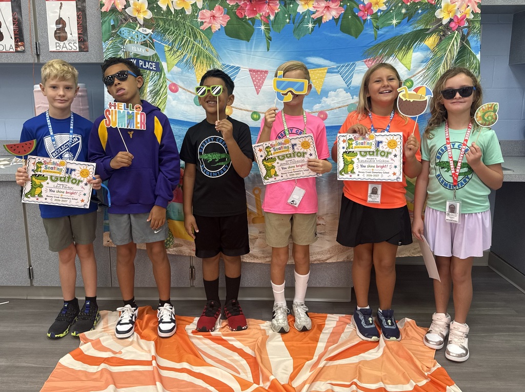 STAR Gators pose in front of a beach-themed backdrop.