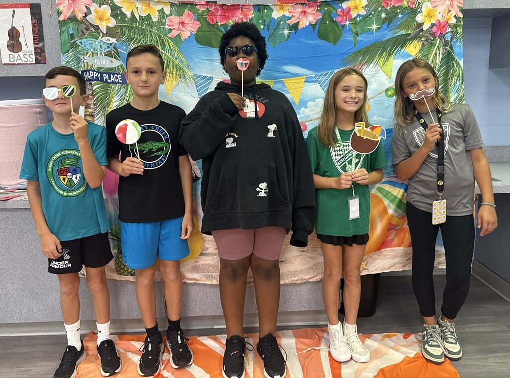 STAR Gators pose in front of a beach-themed backdrop.