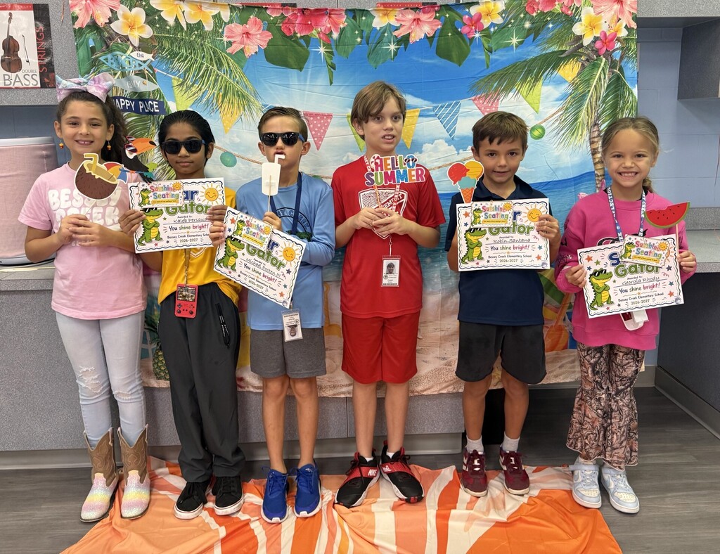 STAR Gators pose in front of a beach-themed backdrop.