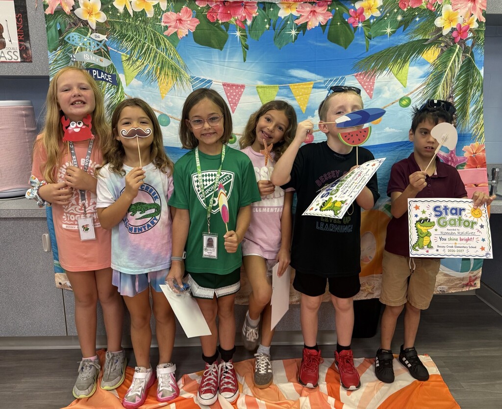STAR Gators pose in front of a beach-themed backdrop.
