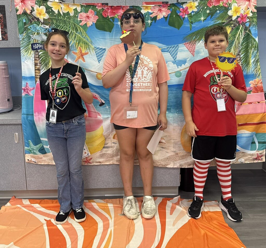 STAR Gators pose in front of a beach-themed backdrop.