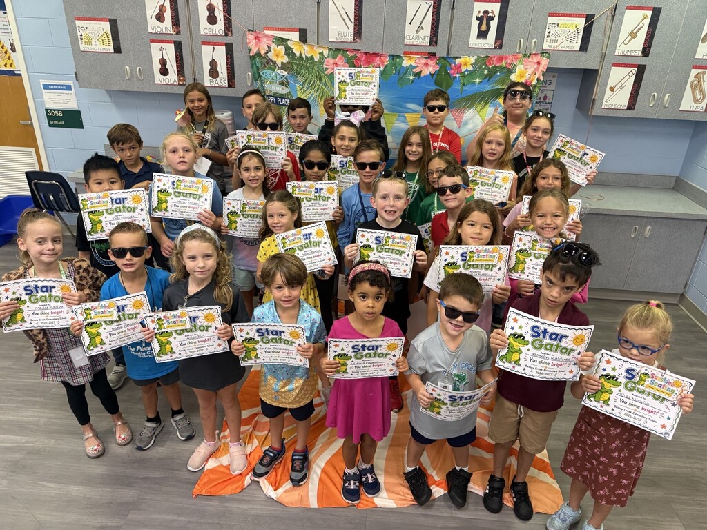 STAR Gators pose in front of a beach-themed backdrop.