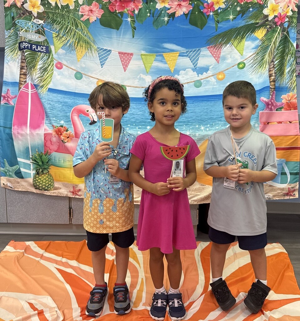 STAR Gators pose in front of a beach-themed backdrop.