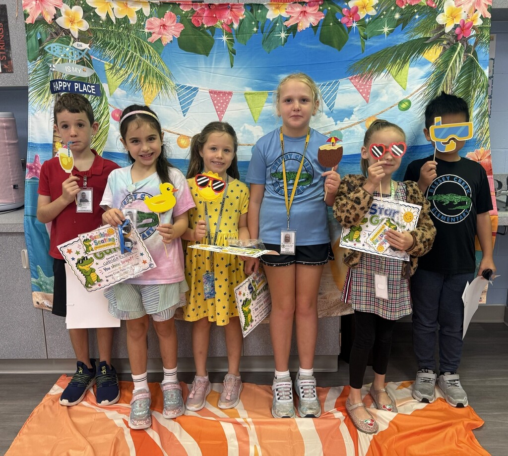 STAR Gators pose in front of a beach-themed backdrop.