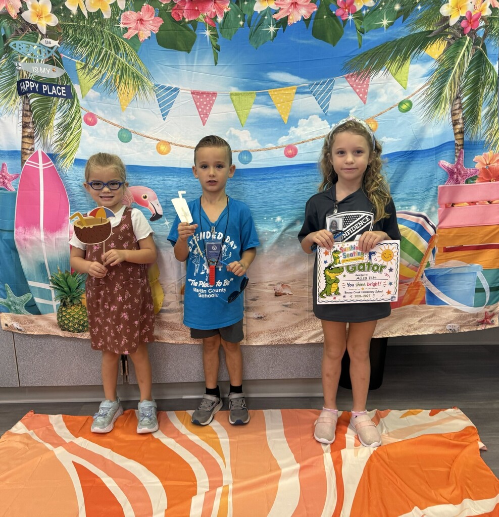 STAR Gators pose in front of a beach-themed backdrop.