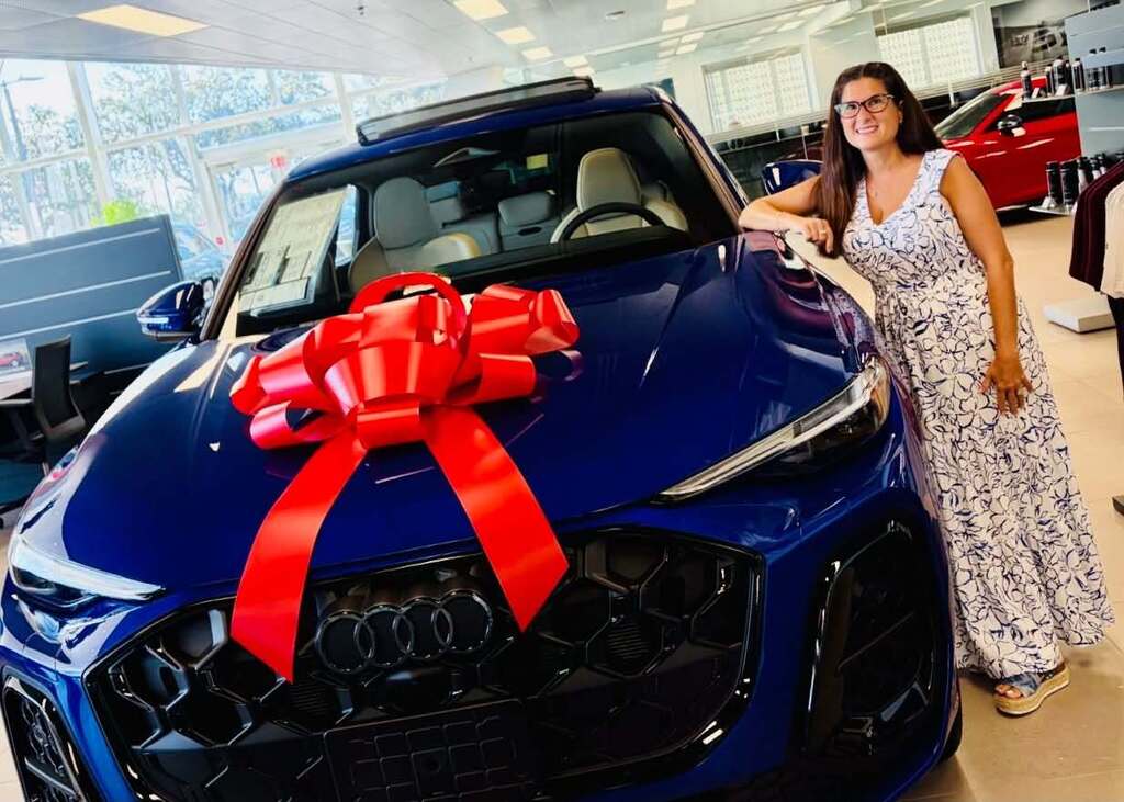 J.D. Parker Elementary School's Teacher of the Year, Mrs. Rosa Bradford standing by car