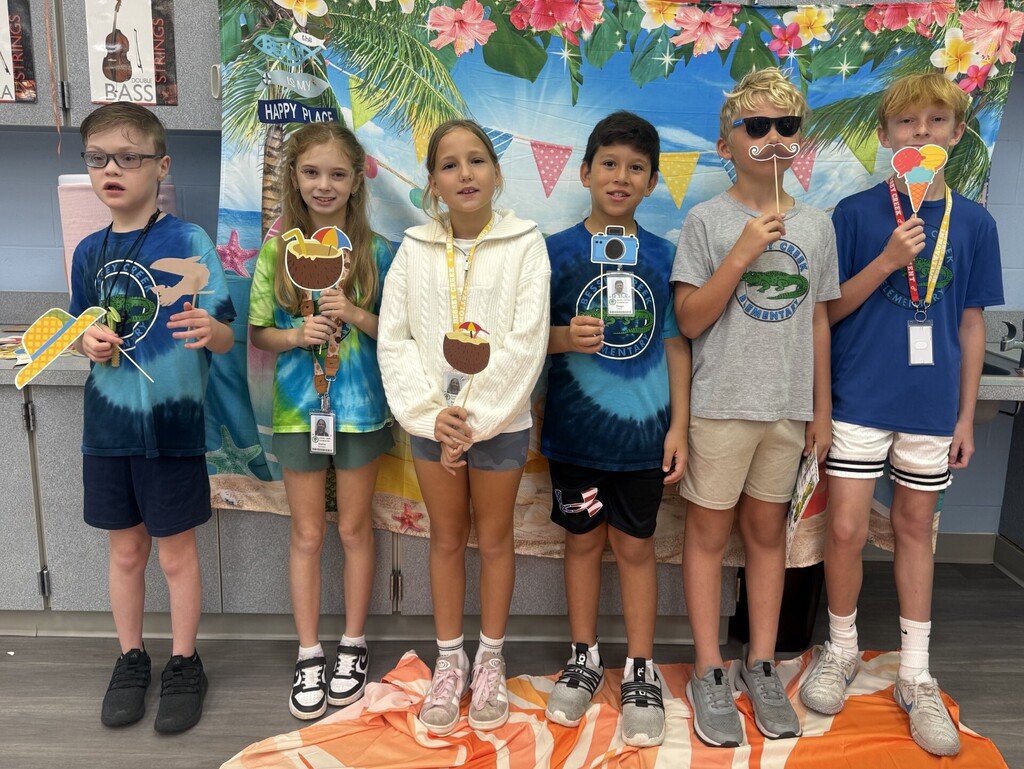 STAR Gators pose in front of a beach-themed backdrop.