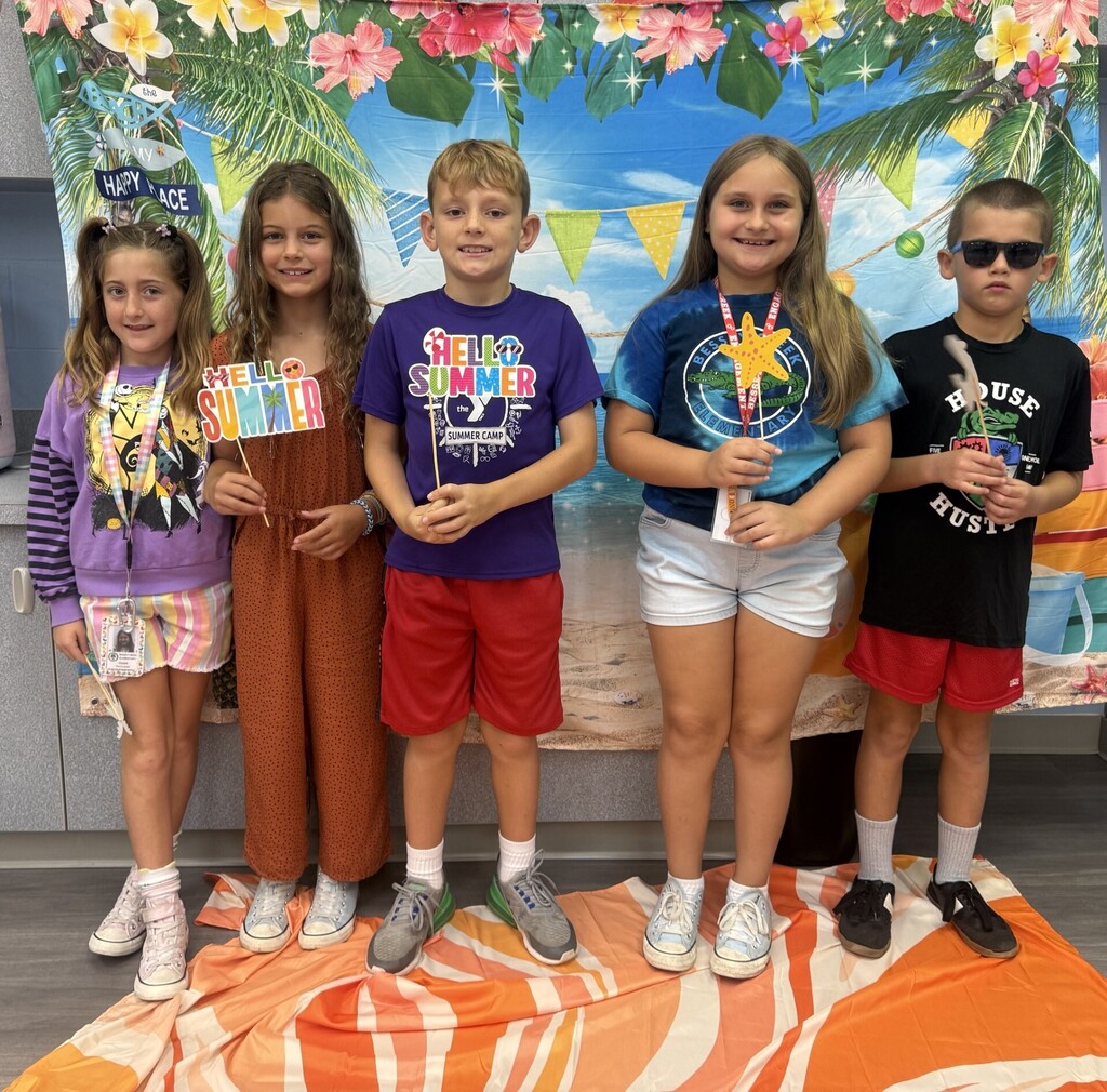 STAR Gators pose in front of a beach-themed backdrop.