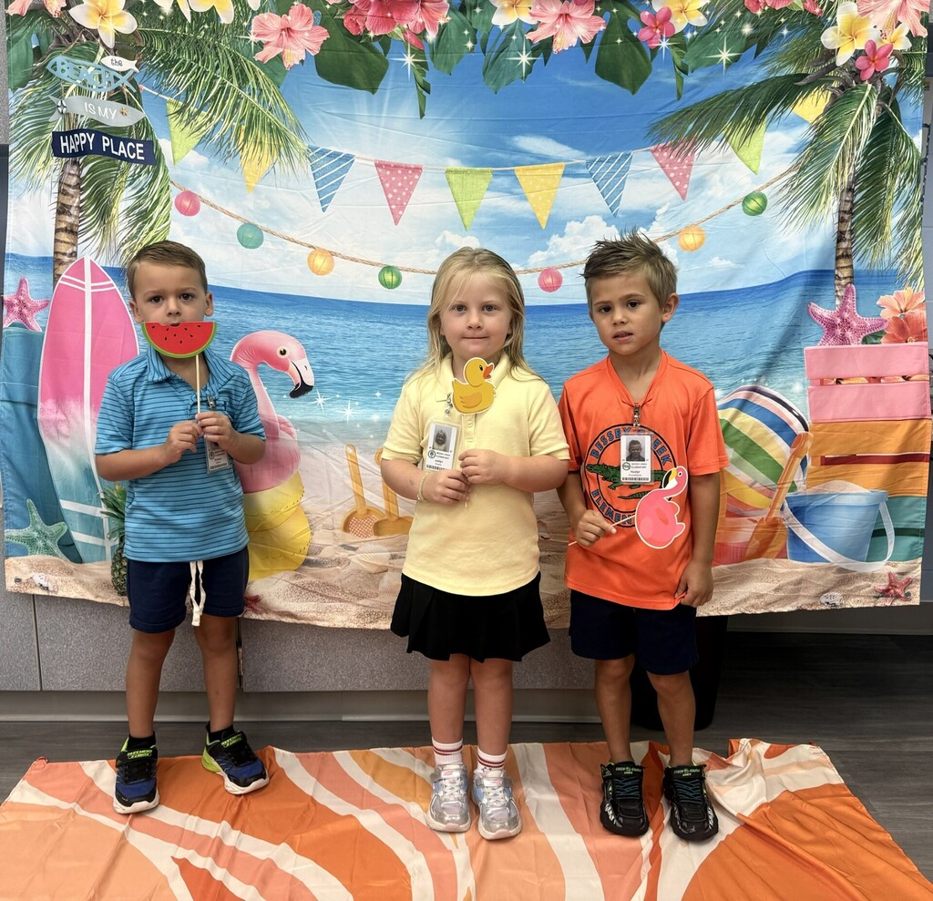 STAR Gators pose in front of a beach-themed backdrop.