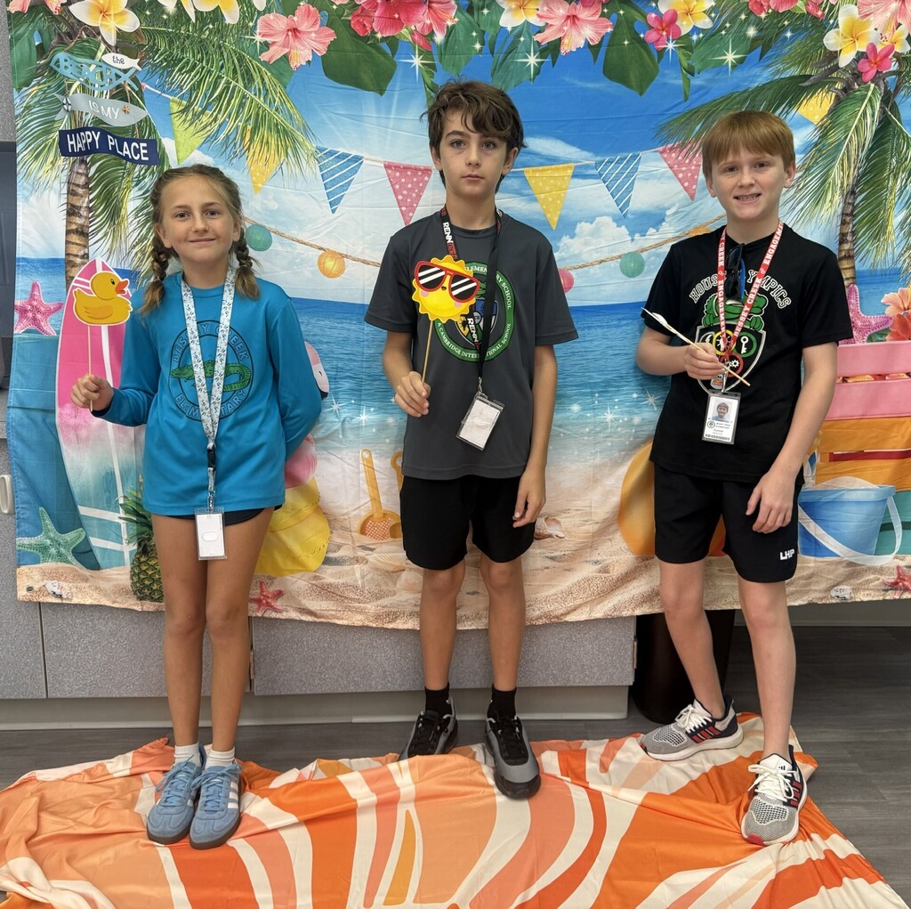 STAR Gators pose in front of a beach-themed backdrop.