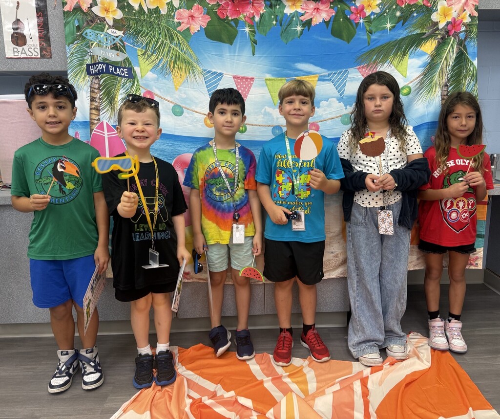 STAR Gators pose in front of a beach-themed backdrop.