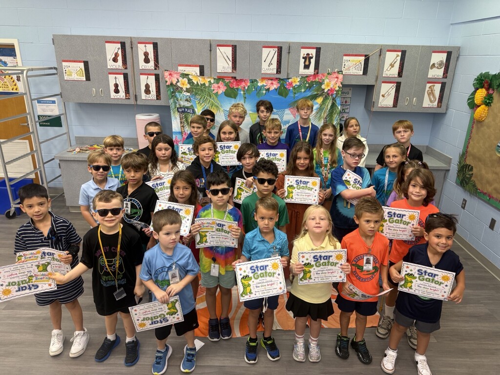 STAR Gators pose in front of a beach-themed backdrop.