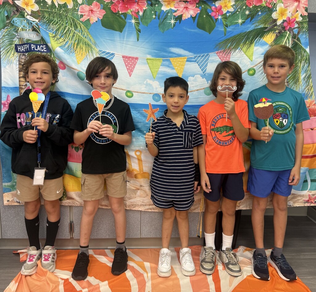 STAR Gators pose in front of a beach-themed backdrop.