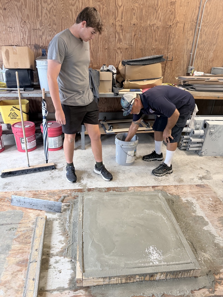 High school students learn how to pour concrete