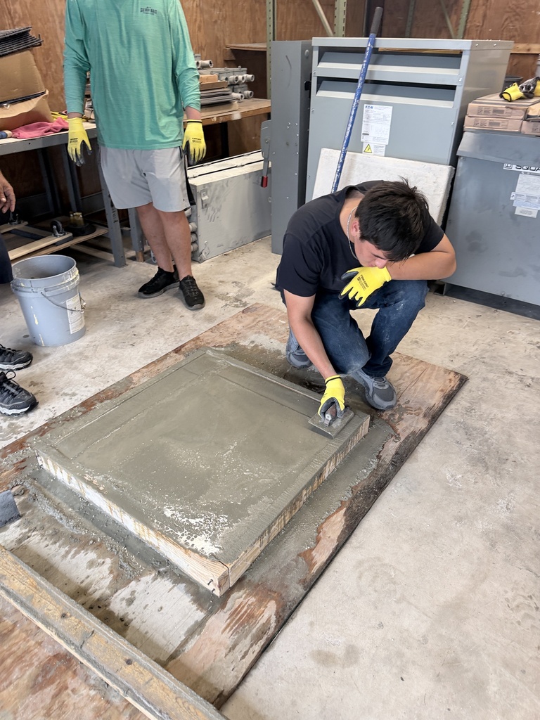 High school students learn how to pour concrete