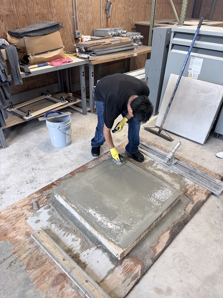 High school students learn how to pour concrete