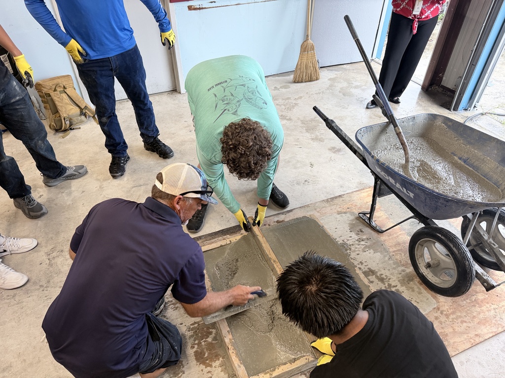 High school students learn how to pour concrete