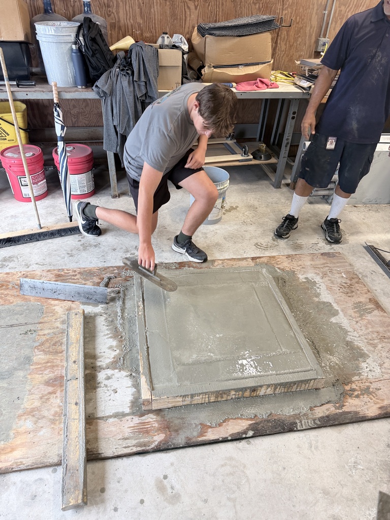 High school students learn how to pour concrete