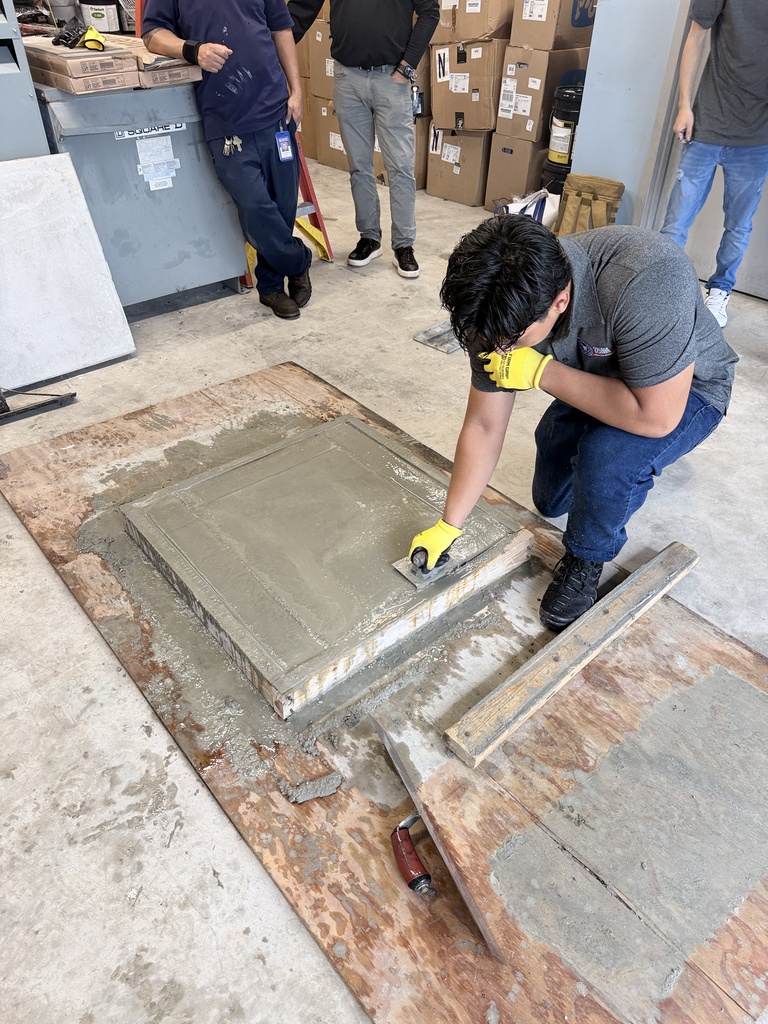 High school students learn how to pour concrete