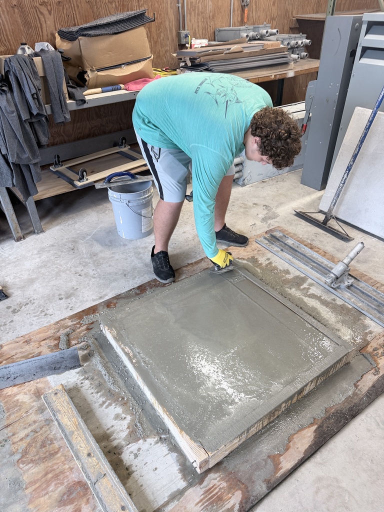 High school students learn how to pour concrete