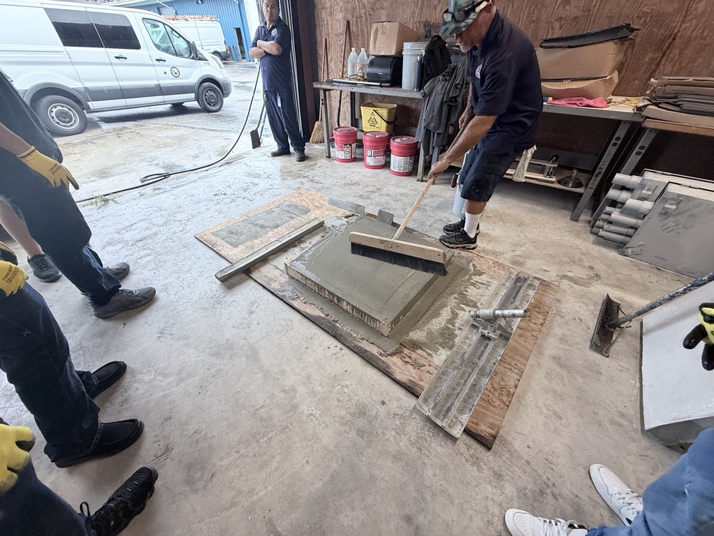 High school students learn how to pour concrete