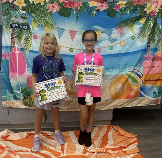 STAR Gator Students stand in front of a beach-themed backdrop.