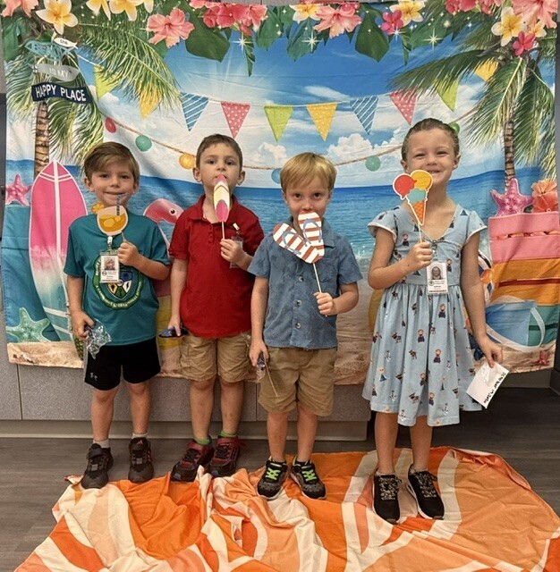 STAR Gator Students stand in front of a beach-themed backdrop.