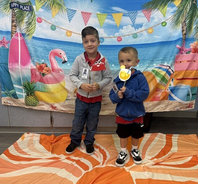 STAR Gators pose in front of a beach-themed backdrop.