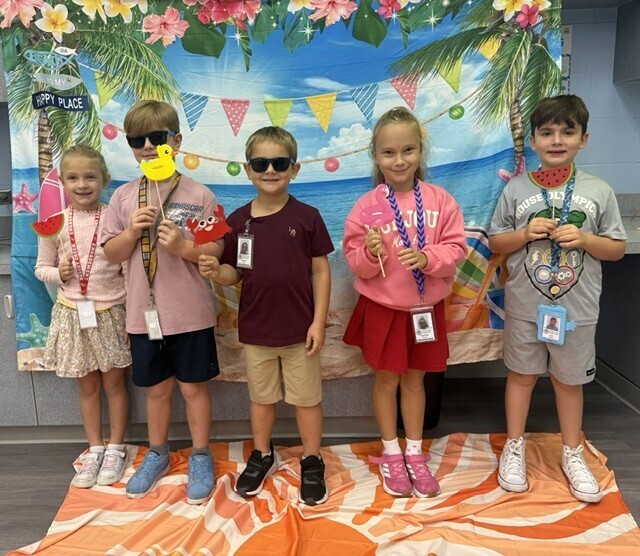 STAR Gators pose in front of a beach-themed backdrop.