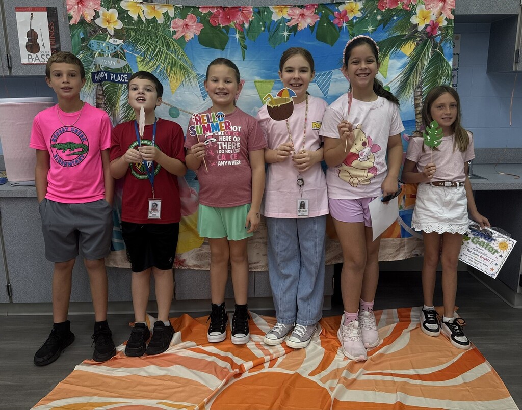 STAR Gators pose in front of a beach-themed backdrop.