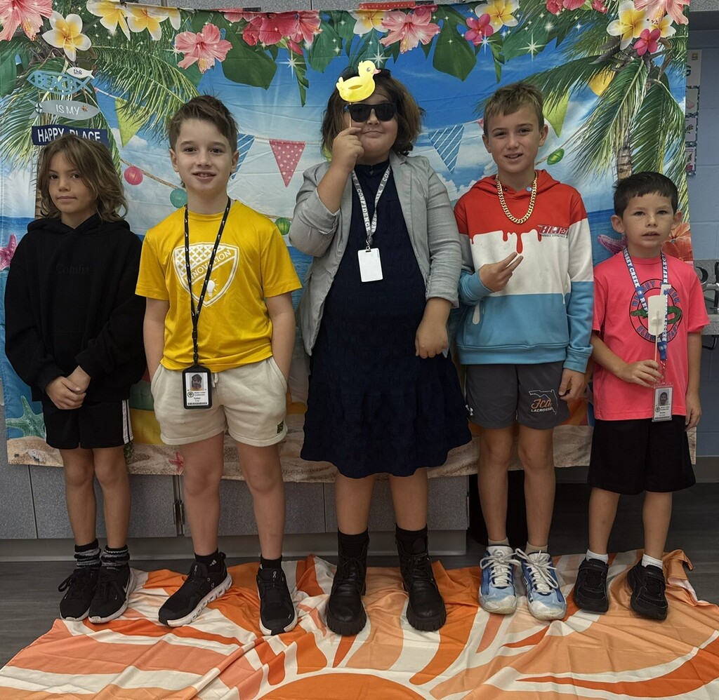 STAR Gators pose in front of a beach-themed backdrop.
