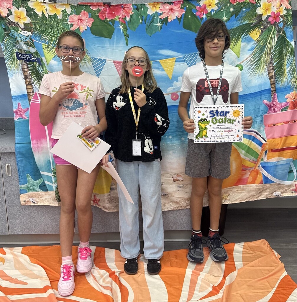 STAR Gators pose in front of a beach-themed backdrop.