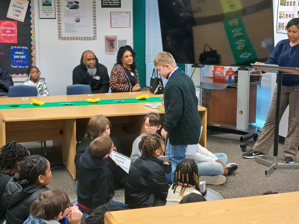 He's even being respectful and kind to others as he returns to his seat after receiving his certificate and medal.