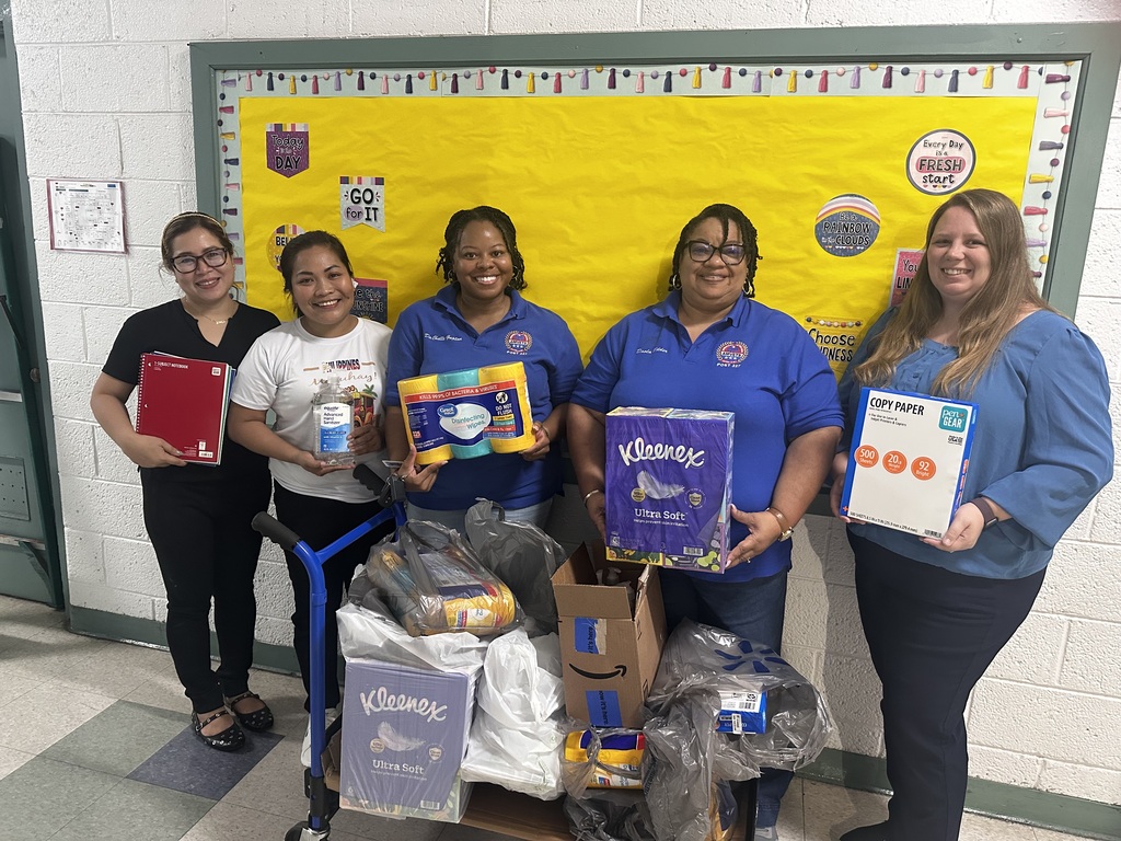 Staff with AMVETS Post 227 holding donations. 