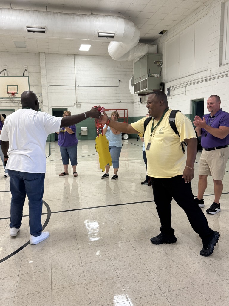 Mr. Locke is cheered on as he accepts his award from Principal Howard. 