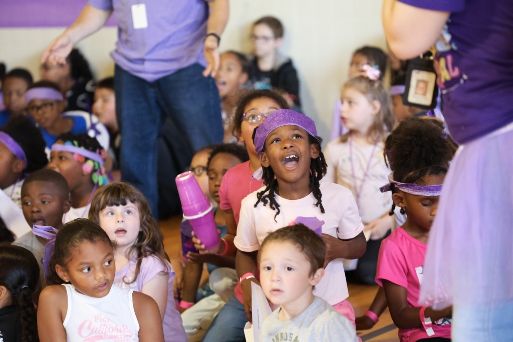 A group of students wearing purple headbands