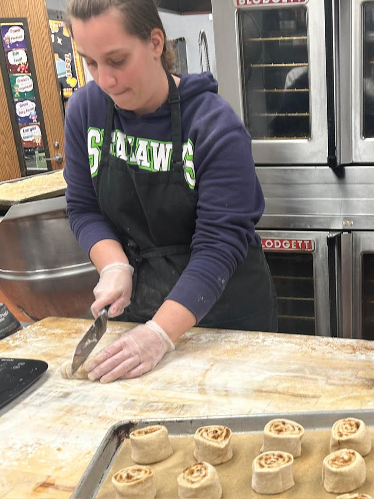Shantel cutting cinnamon rolls