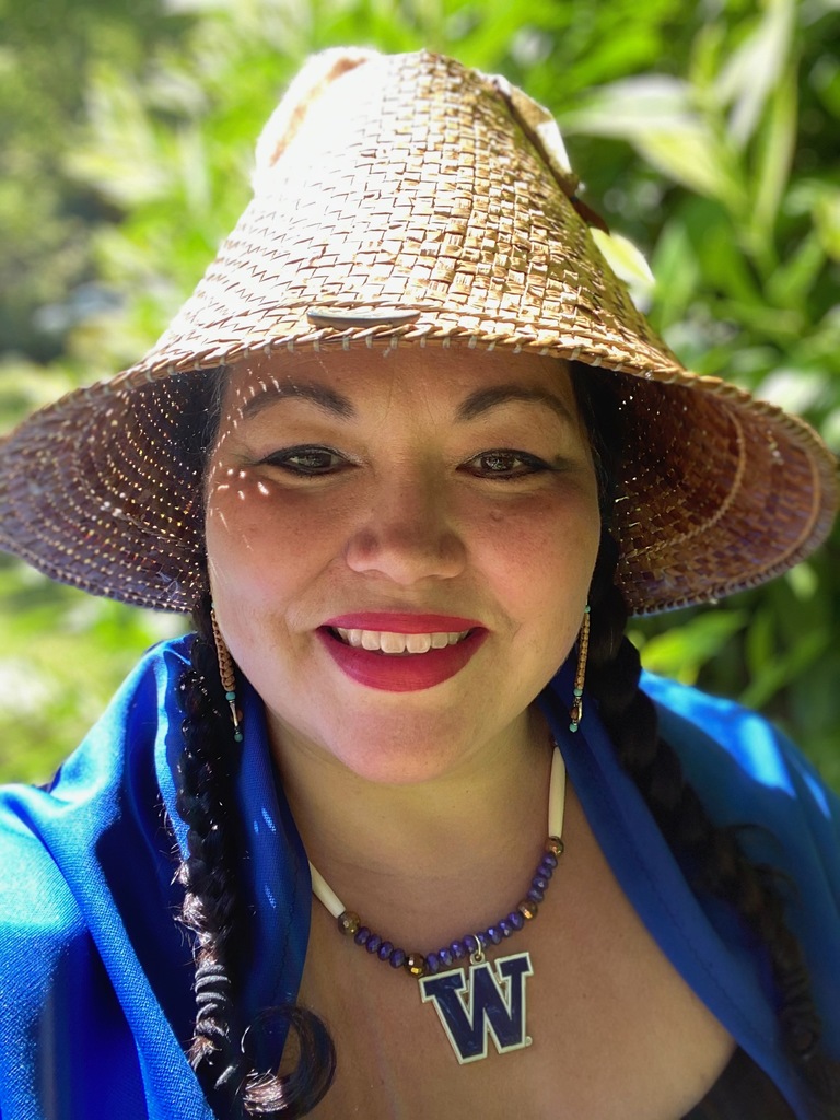 Dr. Craig wearing her traditional cedar hat, smiling