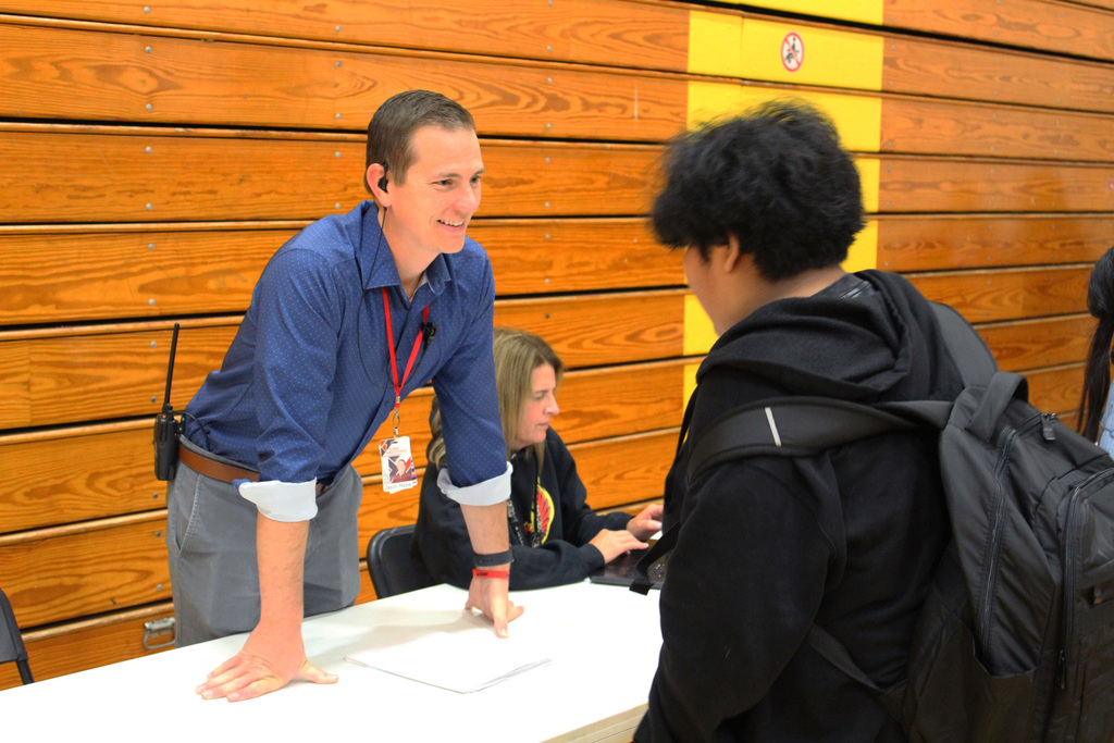 A staff member talks to a student