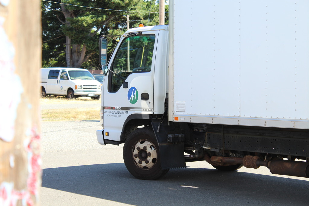 Two white trucks are pictured