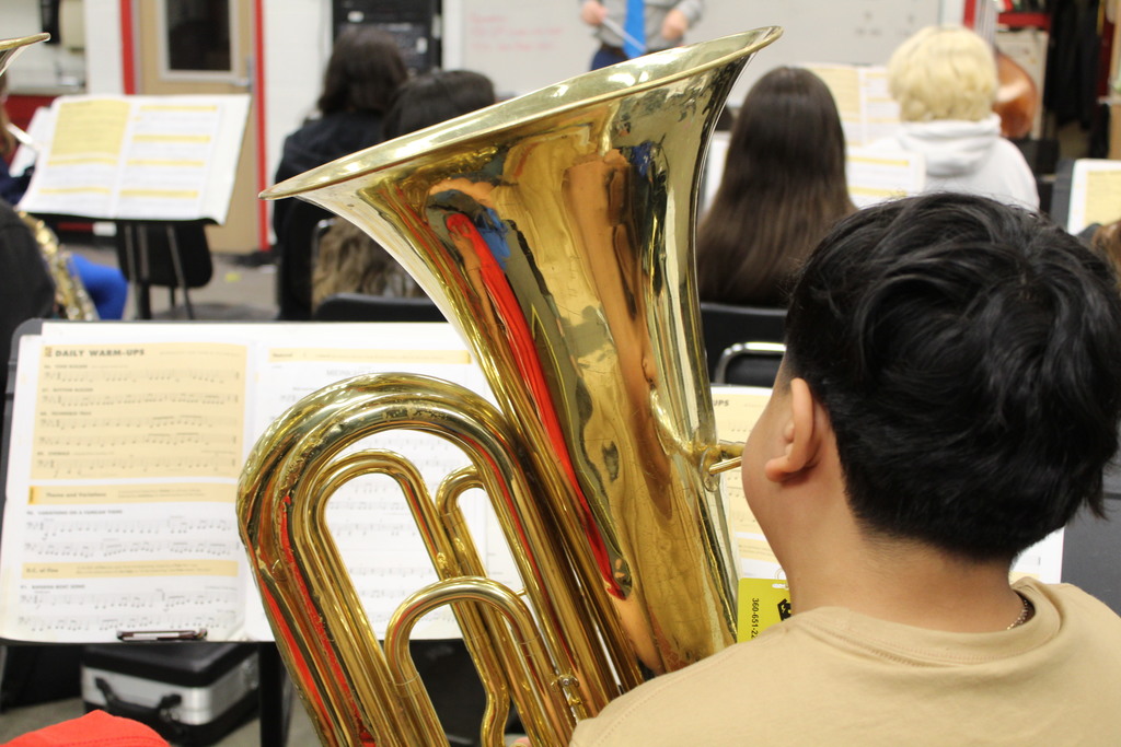 A student is playing a tuba