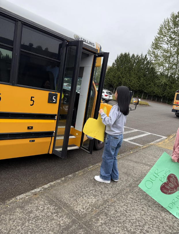 Leadership student giving bus driver their hot water with hot cocoa and coffee.