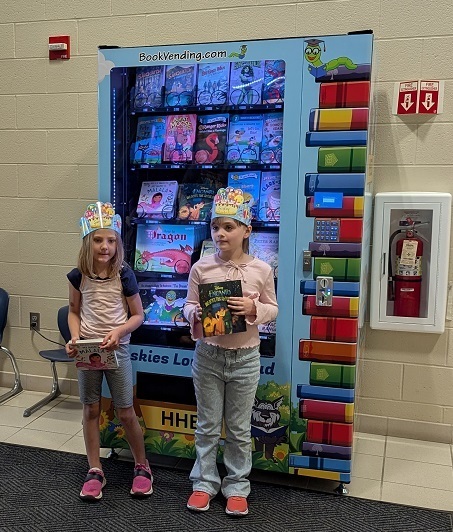2 students receiving a free book