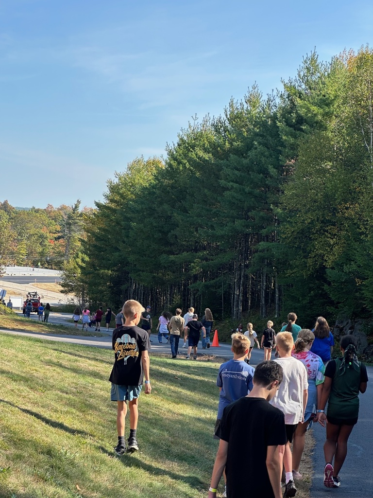 BMS students at the Walkathon walking down the school's driveway as part of their loop around the building. 