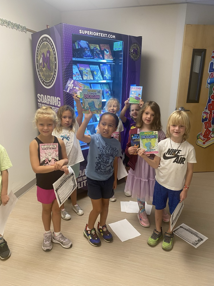students holding books